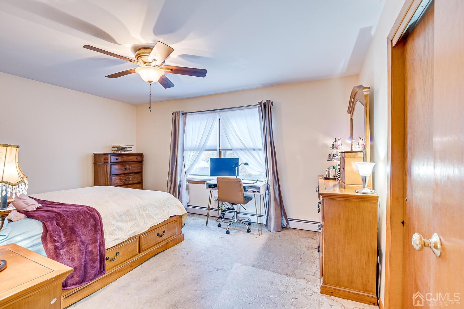 48 Brandywine Road Fords, NJ 08863 - Photo 15 of 29 a bedroom with a bed and a chandelier