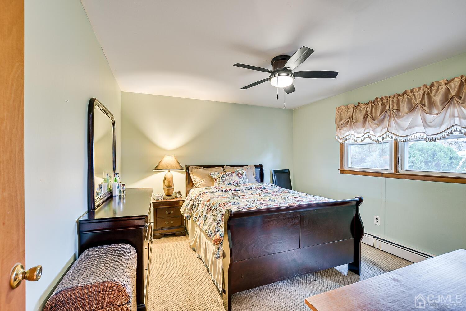 48 Brandywine Road Fords, NJ 08863 - Photo 18 of 29 a bedroom with a bed and a chandelier