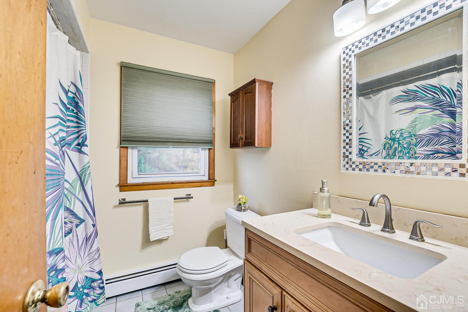 48 Brandywine Road Fords, NJ 08863 - Photo 19 of 29 a bathroom with a sink a toilet and a mirror