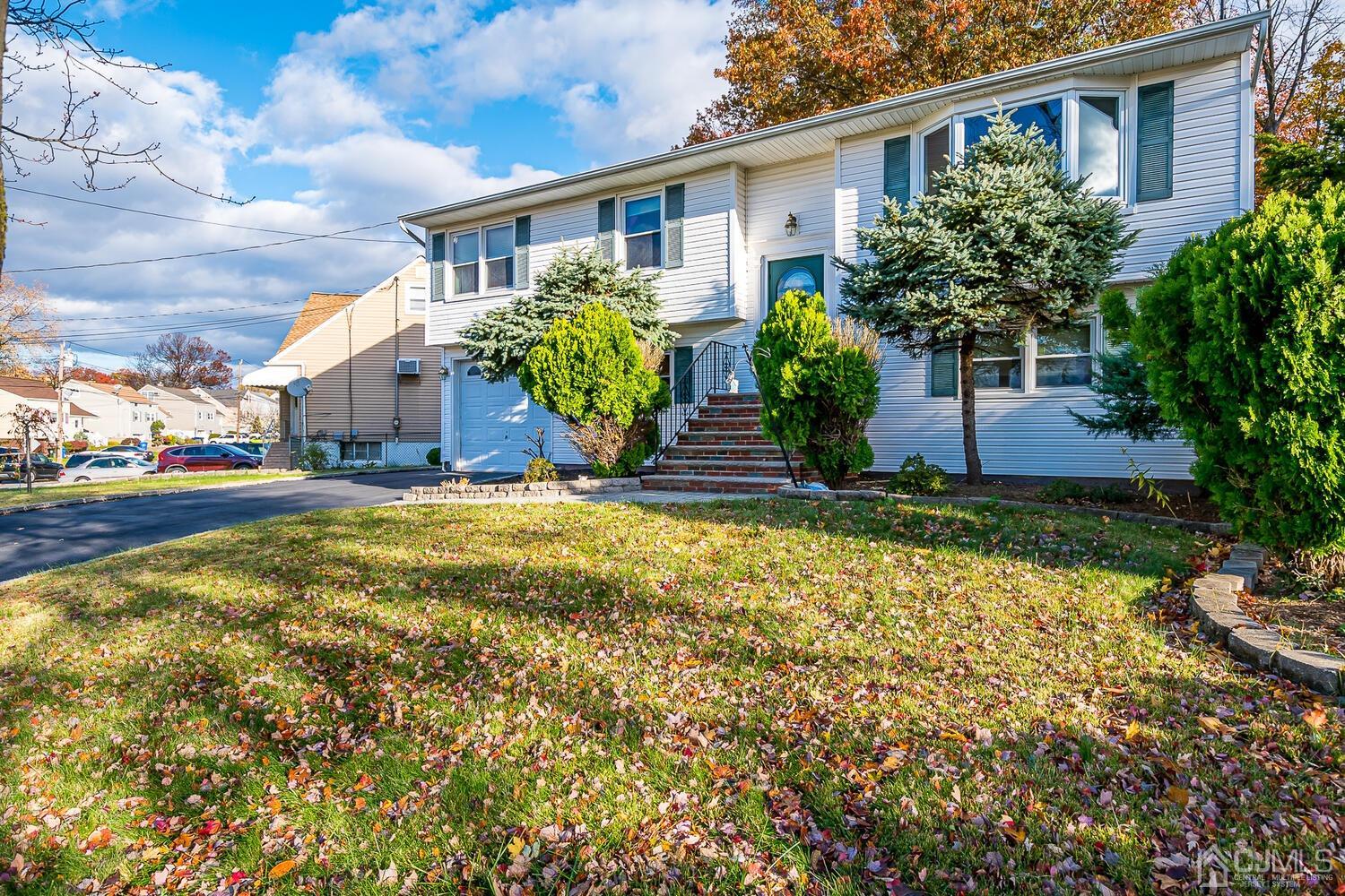 48 Brandywine Road Fords, NJ 08863 - Photo 3 of 29 a front view of house with yard and trees around
