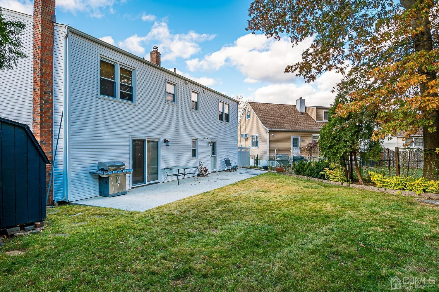 48 Brandywine Road Fords, NJ 08863 - Photo 27 of 29 a backyard of a house with barbeque oven and outdoor seating