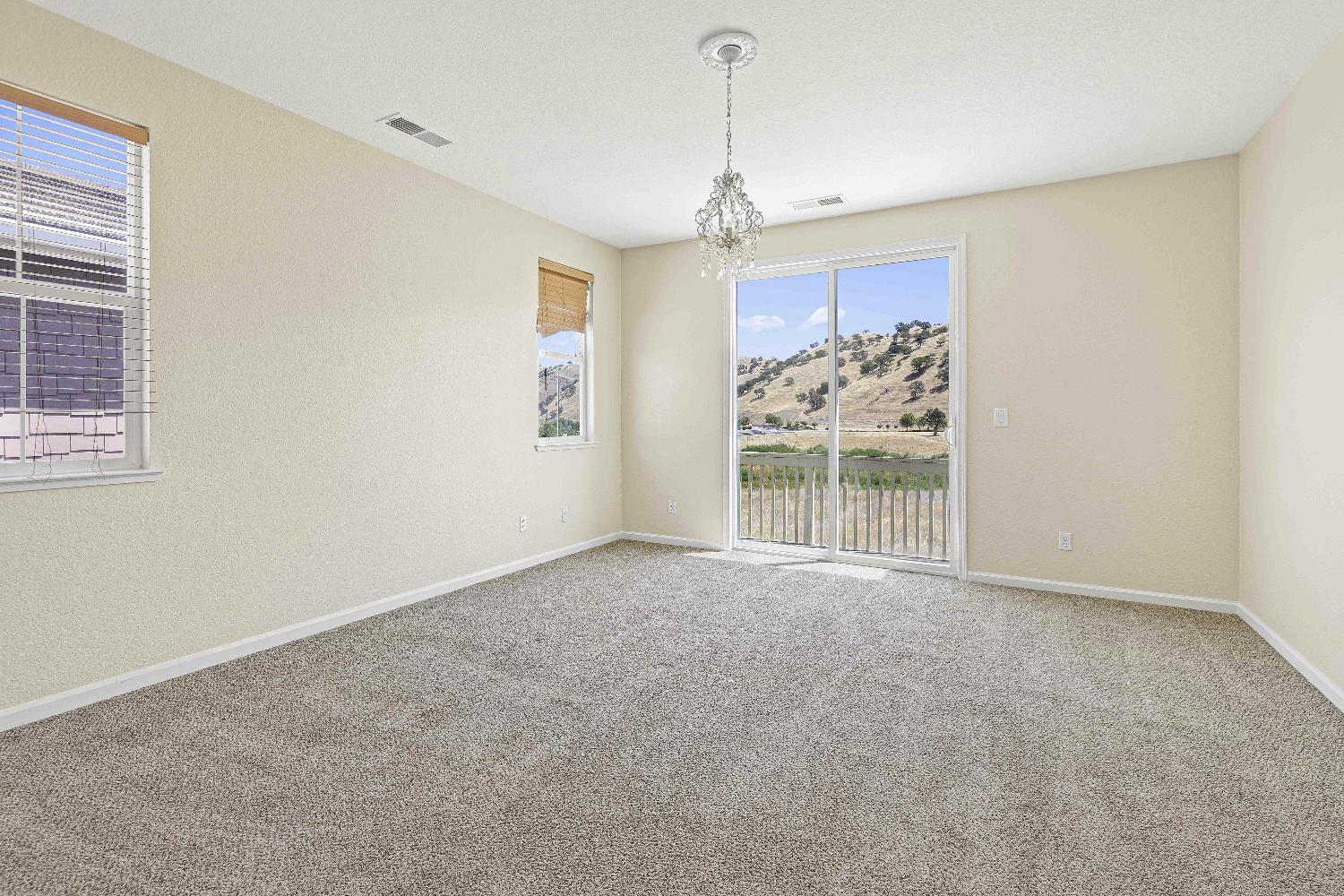 9397 Vintner Circle Patterson, CA 95363 - Photo 19 of 38 a view of a windows and chandelier in a room