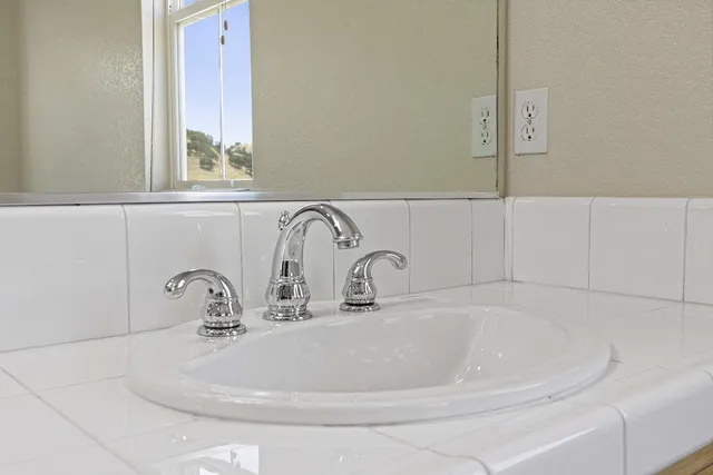 a bathroom with a sink and mirror