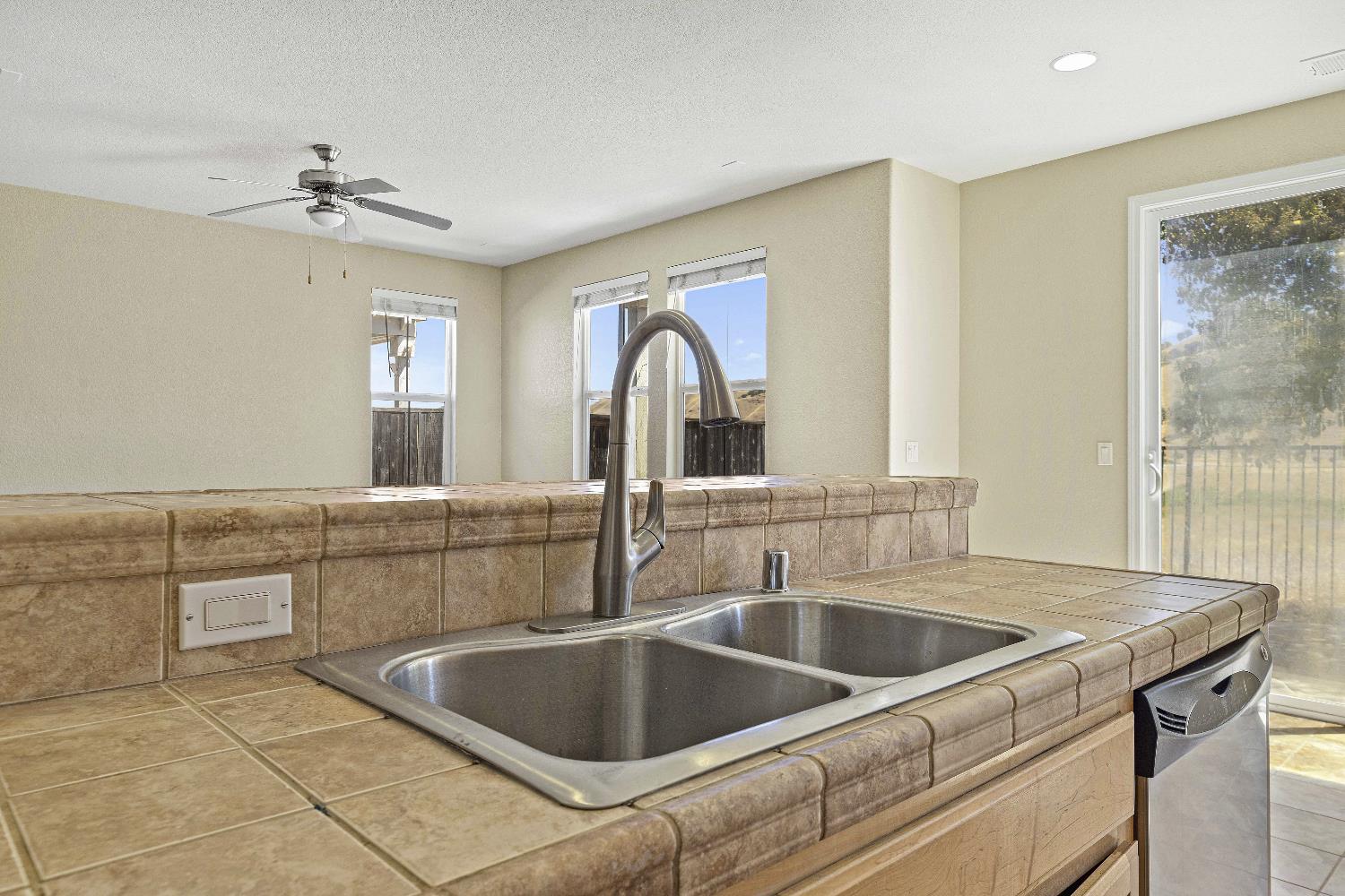 9397 Vintner Circle Patterson, CA 95363 - Photo 8 of 38 a kitchen with a sink cabinets and window