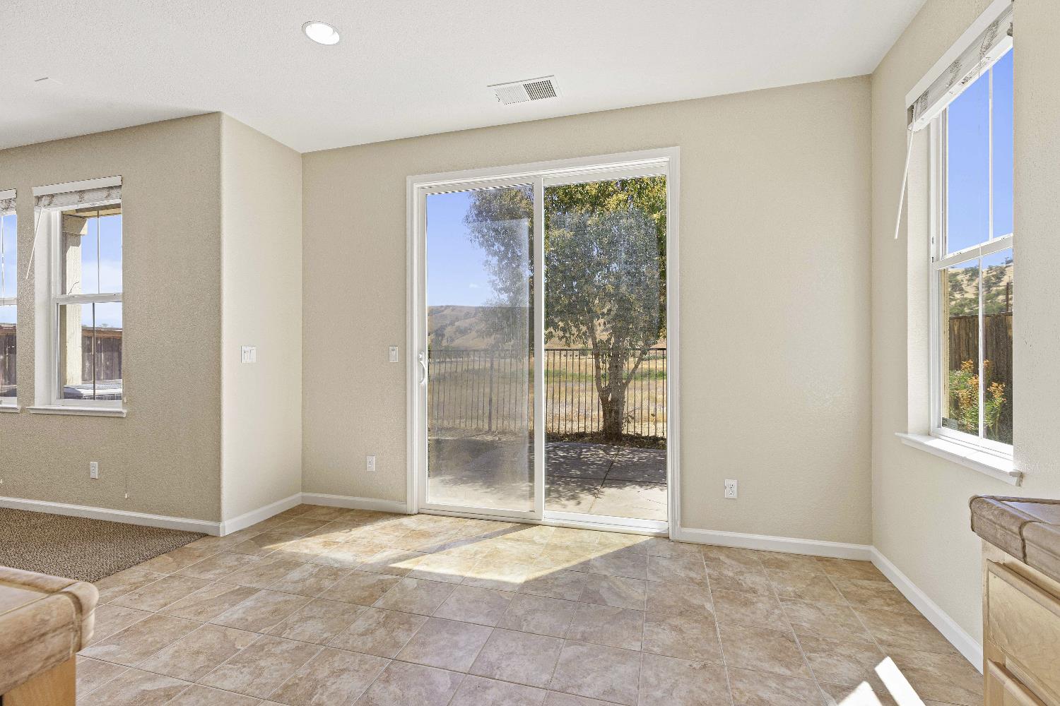 9397 Vintner Circle Patterson, CA 95363 - Photo 9 of 38 a view of an empty room with a window
