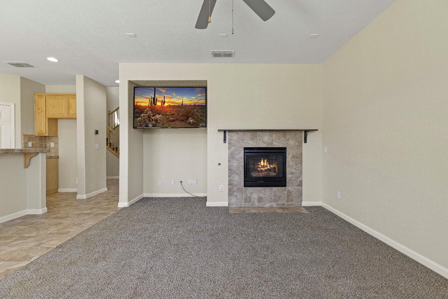 9397 Vintner Circle Patterson, CA 95363 - Photo 10 of 38 a view of an empty room with a fireplace