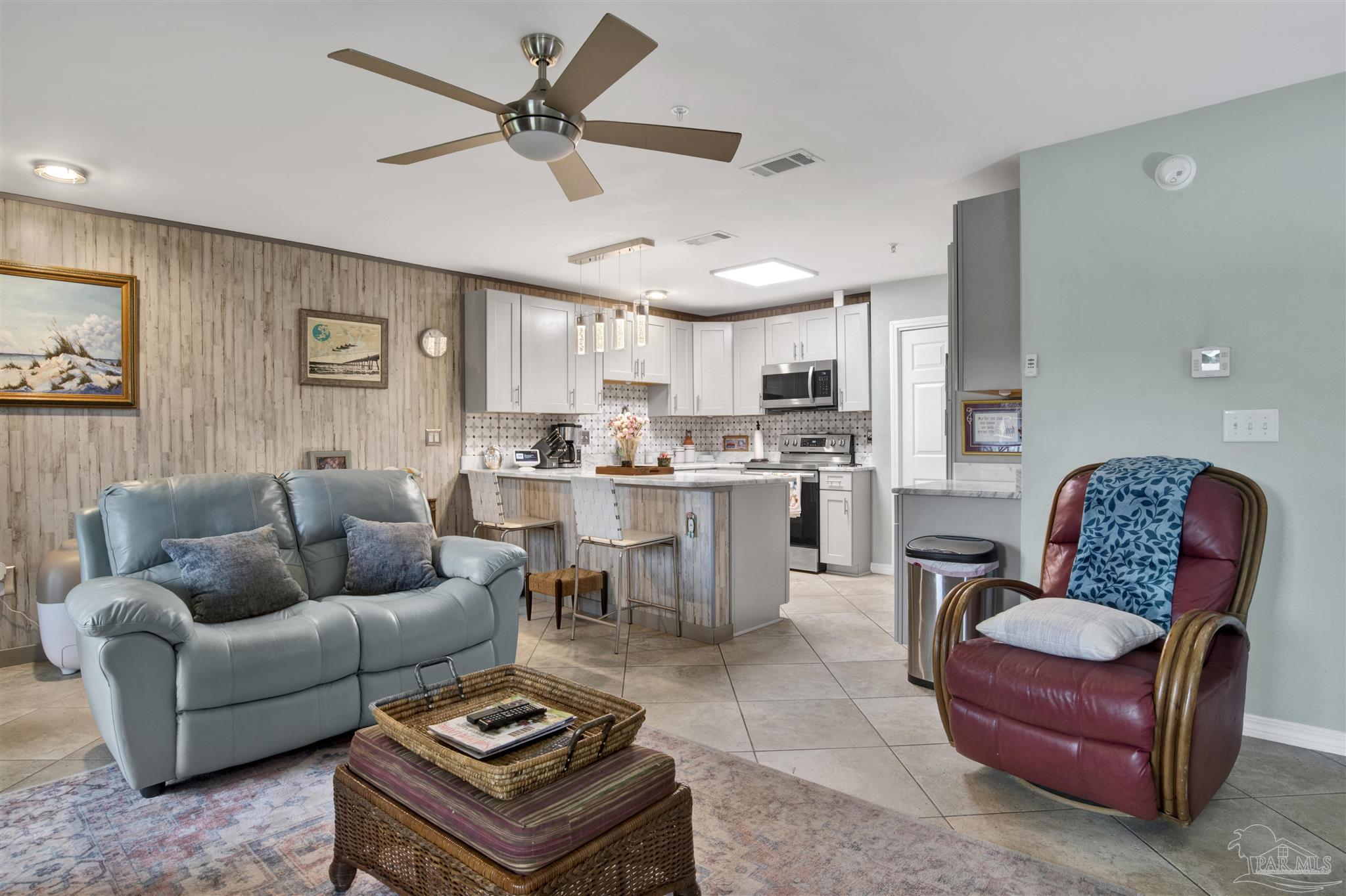 13351 Johnson Beach Road, Unit 203E Perdido Key, FL 32507 - Photo 6 of 55 a living room with furniture kitchen view and a chandelier