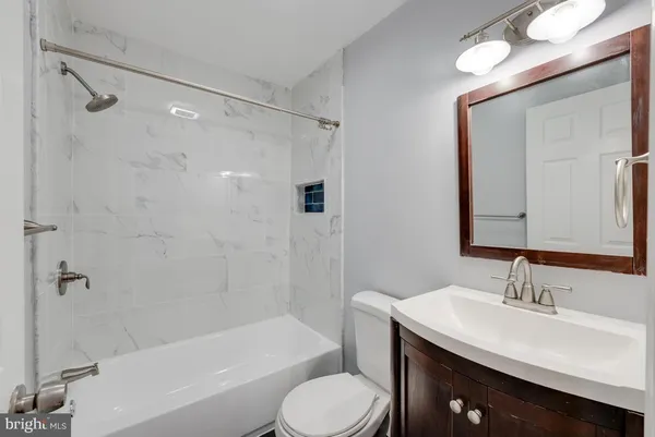a bathroom with a sink toilet tub and shower