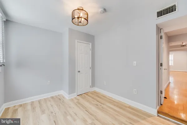 a view of a room with wooden floor