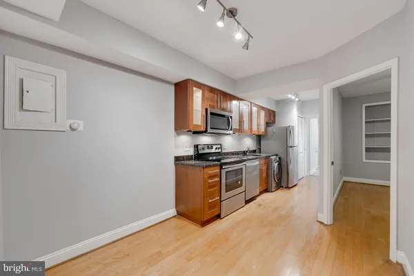 a kitchen with stainless steel appliances granite countertop a stove a sink and a refrigerator