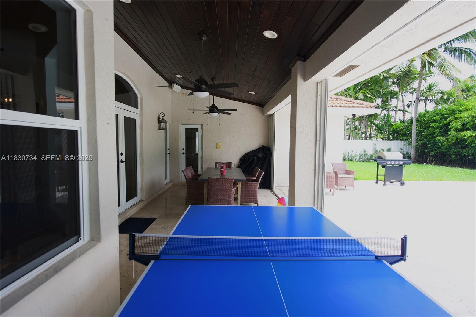 12401 Southwest 77th Street, Unit 12401 Miami, FL 33183 - Photo 18 of 95 a view of a patio with table and chairs potted plants with wooden floor
