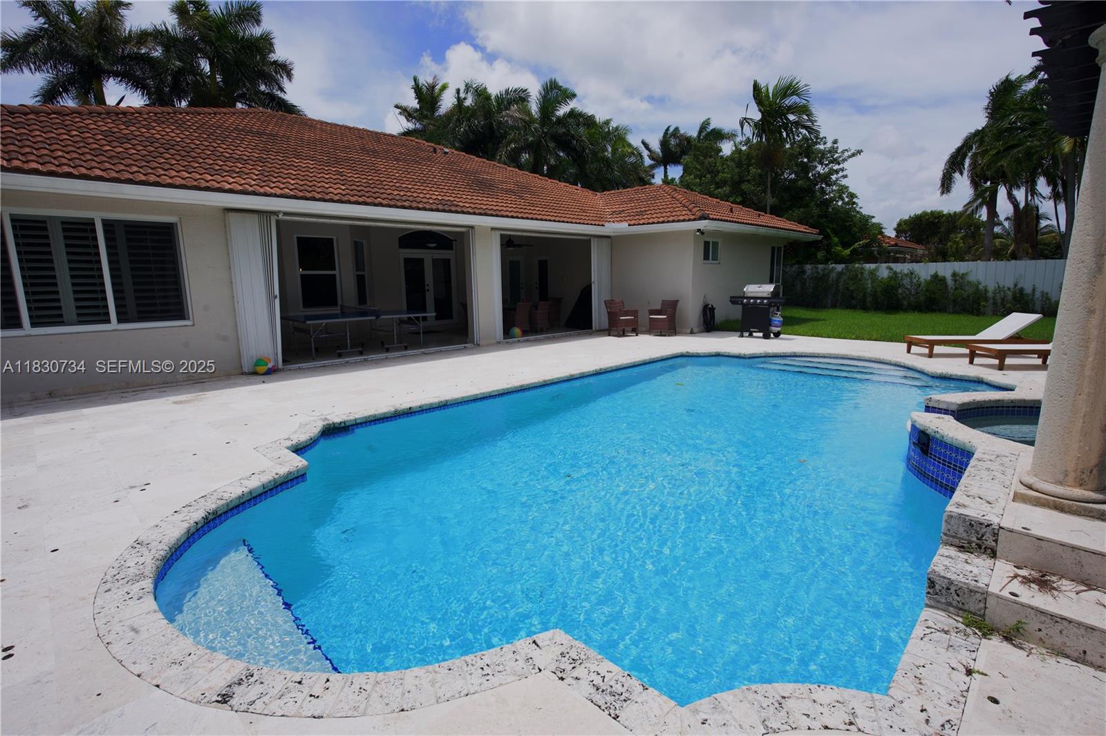 12401 Southwest 77th Street, Unit 12401 Miami, FL 33183 - Photo 22 of 95 a view of a house with a swimming pool and sitting area