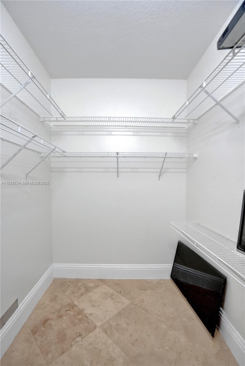 12401 Southwest 77th Street, Unit 12401 Miami, FL 33183 - Photo 23 of 95 a view of a room with racks on the wall