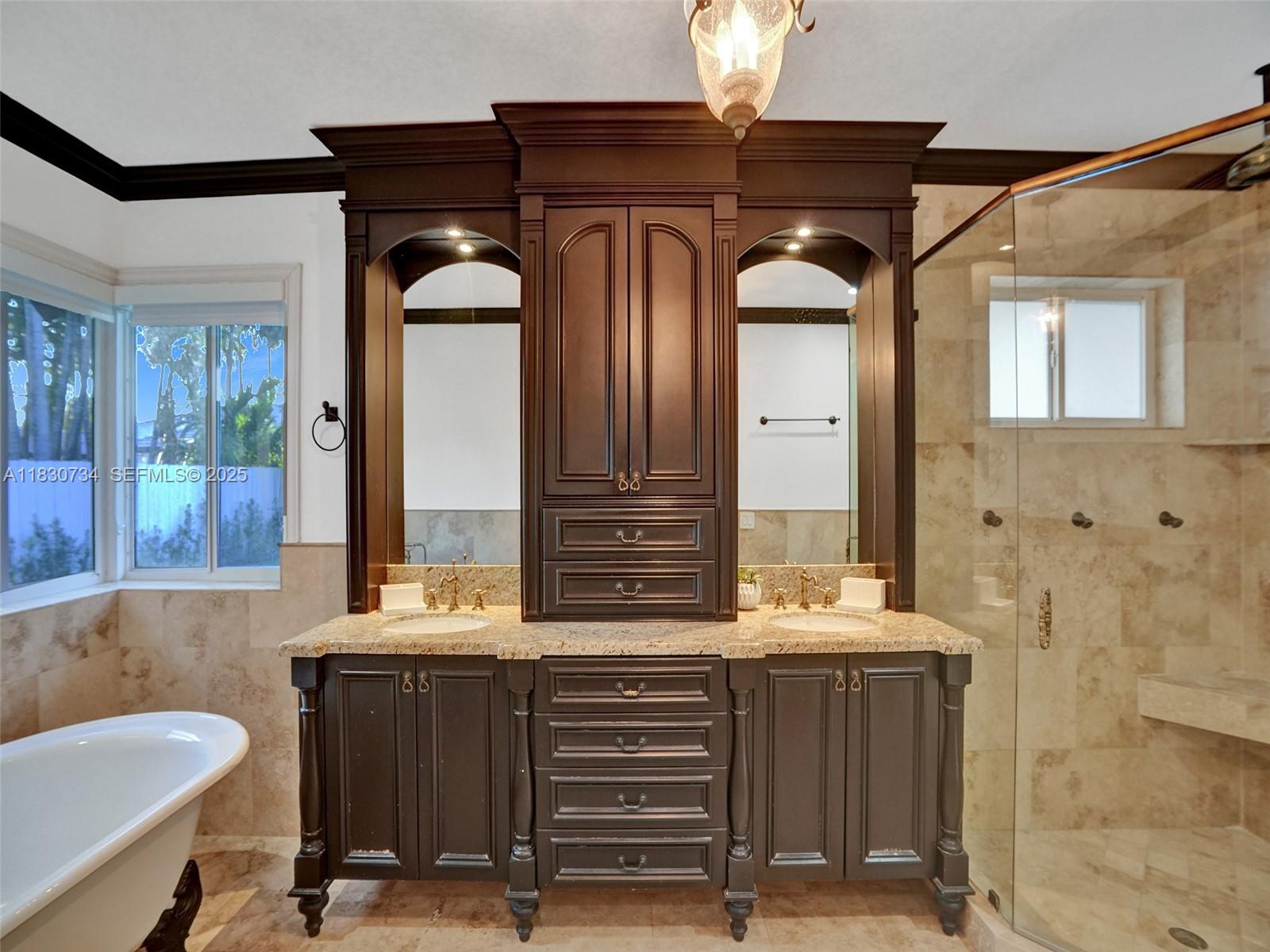 12401 Southwest 77th Street, Unit 12401 Miami, FL 33183 - Photo 24 of 95 a bathroom with a granite countertop sink a mirror and a bathtub