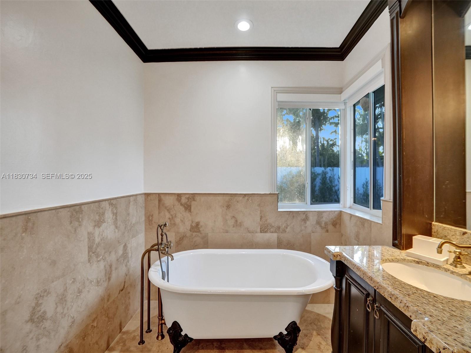 12401 Southwest 77th Street, Unit 12401 Miami, FL 33183 - Photo 28 of 95 a bathroom with a bathtub and a sink