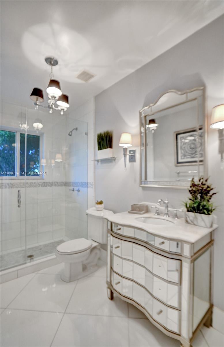 12401 Southwest 77th Street, Unit 12401 Miami, FL 33183 - Photo 30 of 95 a bathroom with a sink a toilet and a mirror