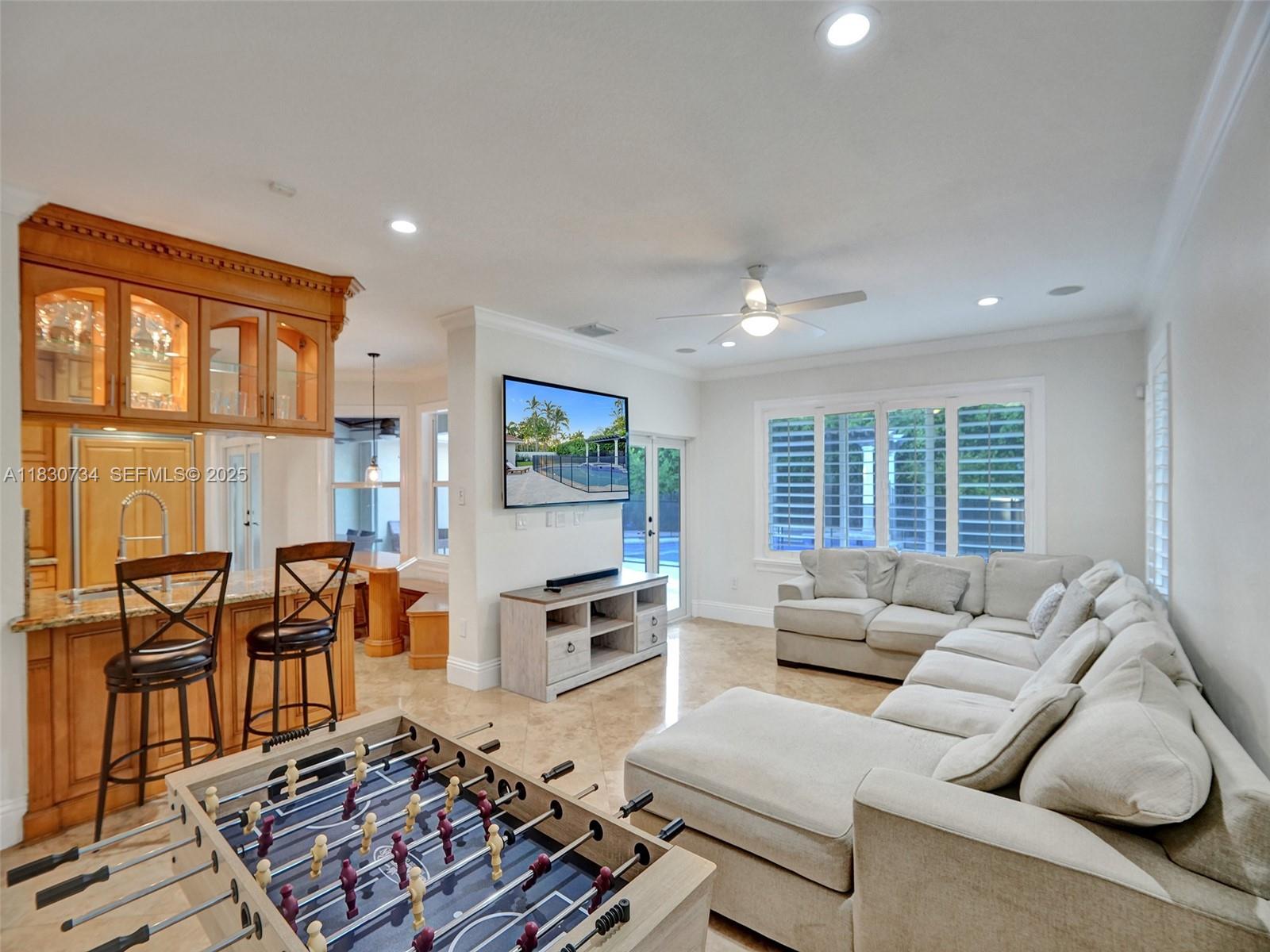 12401 Southwest 77th Street, Unit 12401 Miami, FL 33183 - Photo 32 of 95 a living room with furniture and a flat screen tv