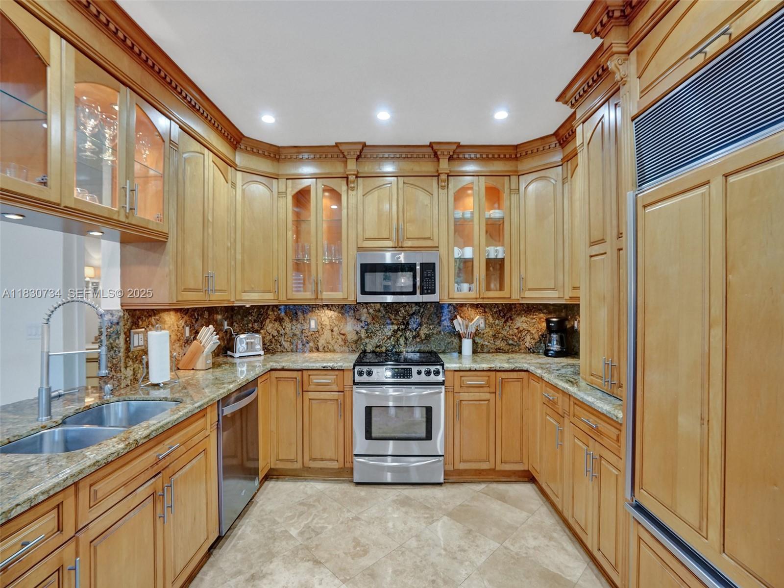 12401 Southwest 77th Street, Unit 12401 Miami, FL 33183 - Photo 38 of 95 a kitchen with stainless steel appliances granite countertop a stove a sink and a refrigerator