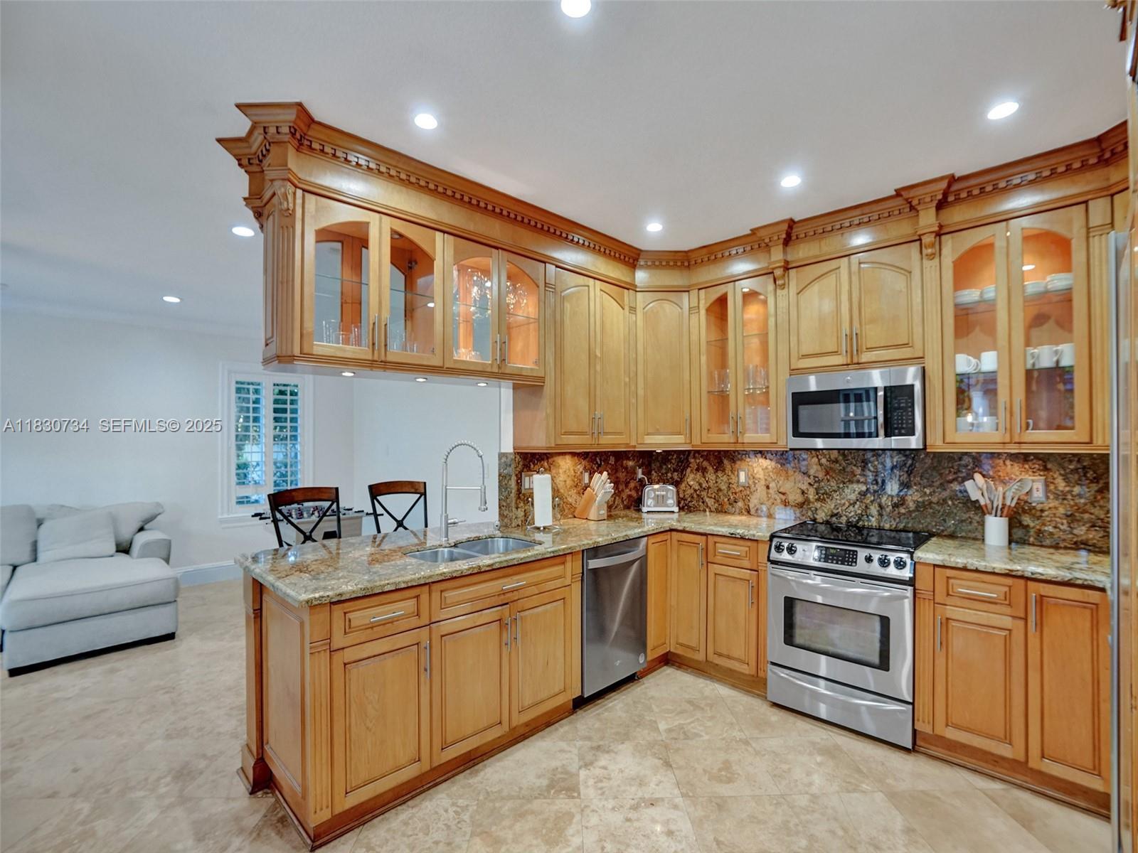 12401 Southwest 77th Street, Unit 12401 Miami, FL 33183 - Photo 39 of 95 a kitchen with stainless steel appliances granite countertop a stove sink and cabinets