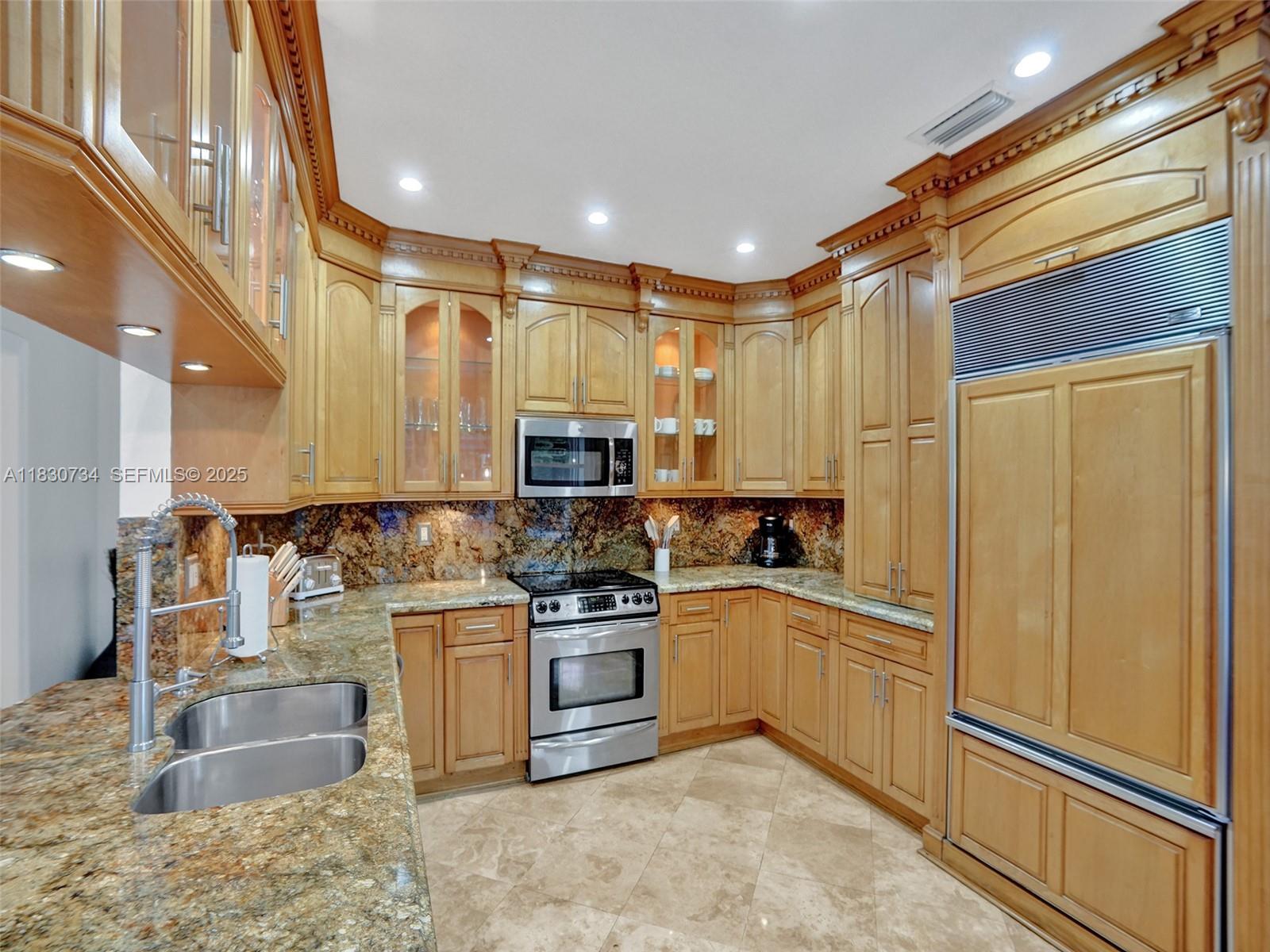 12401 Southwest 77th Street, Unit 12401 Miami, FL 33183 - Photo 41 of 95 a kitchen with stainless steel appliances granite countertop a sink stove and refrigerator