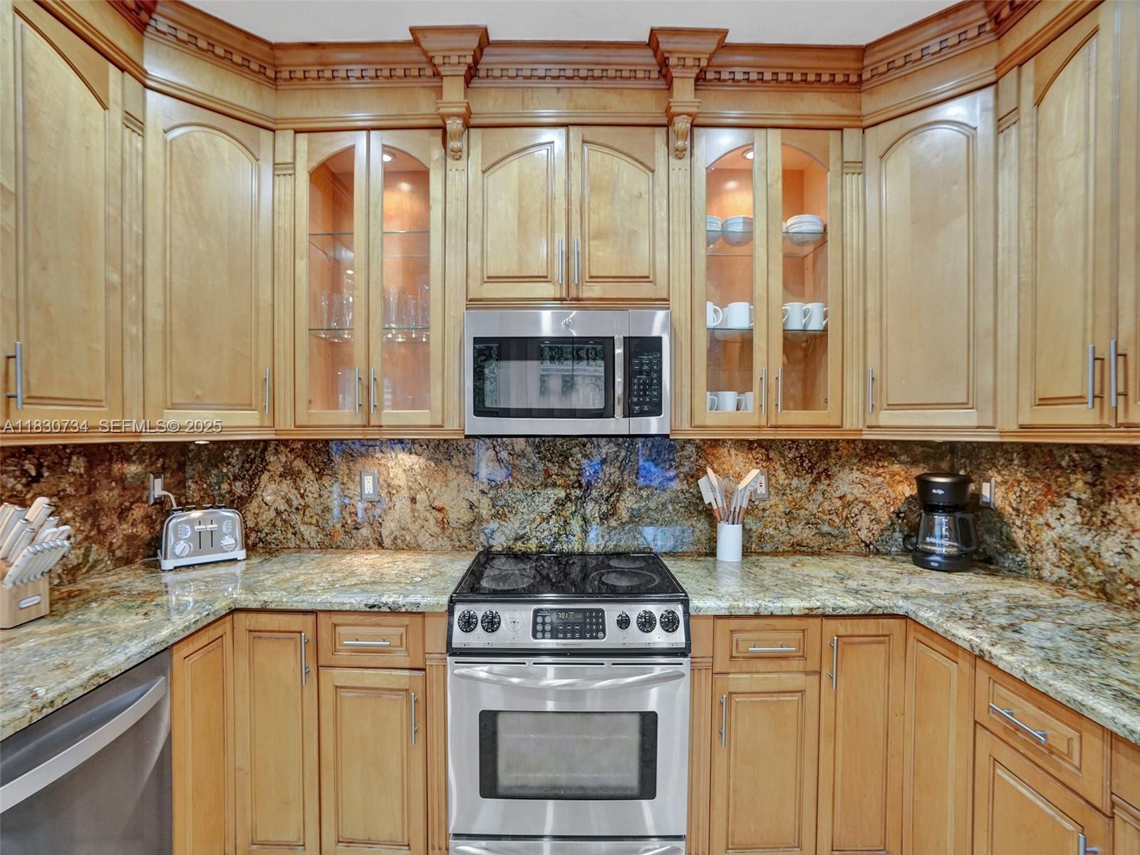 12401 Southwest 77th Street, Unit 12401 Miami, FL 33183 - Photo 42 of 95 a kitchen with stainless steel appliances granite countertop a sink a stove and a granite counter tops