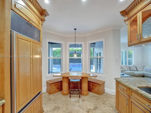 a bathroom with a granite countertop sink a toilet a mirror and shower