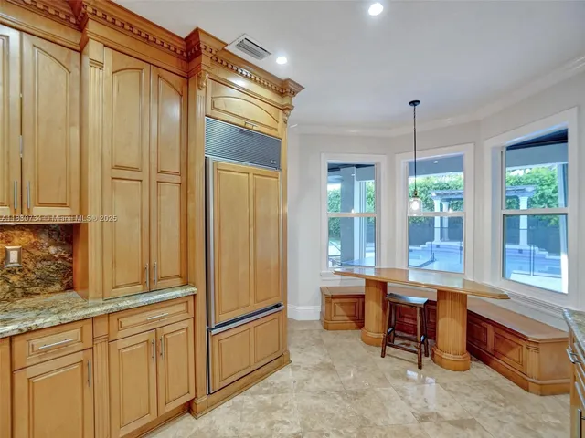 a large bed sitting in a bedroom next to a window