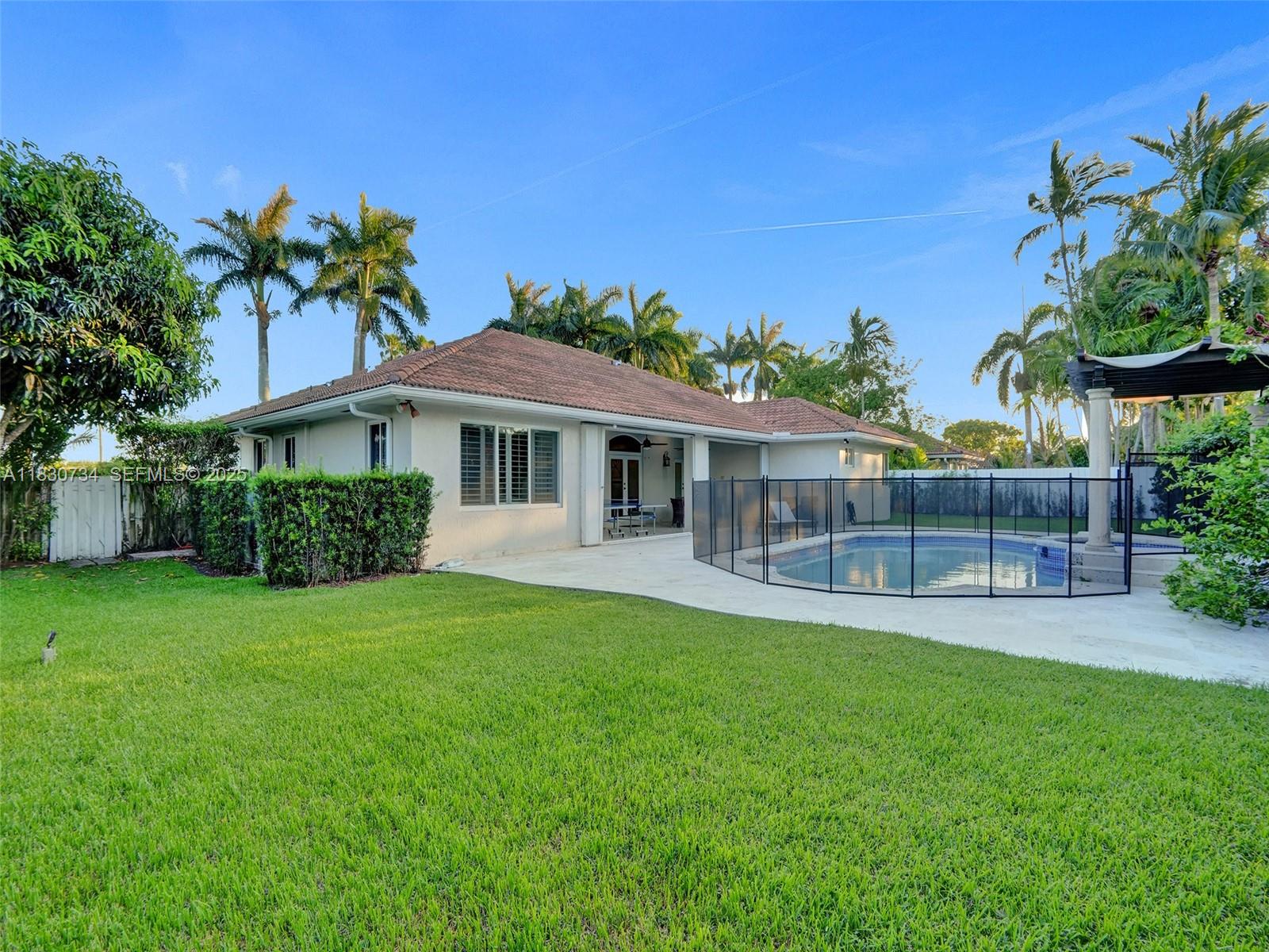 12401 Southwest 77th Street, Unit 12401 Miami, FL 33183 - Photo 47 of 95 a view of a house with a yard and potted plants