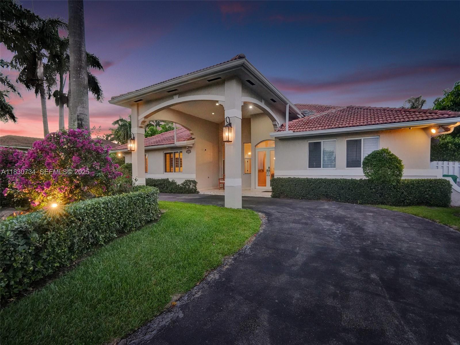 12401 Southwest 77th Street, Unit 12401 Miami, FL 33183 - Photo 5 of 95 a front view of a house with a yard