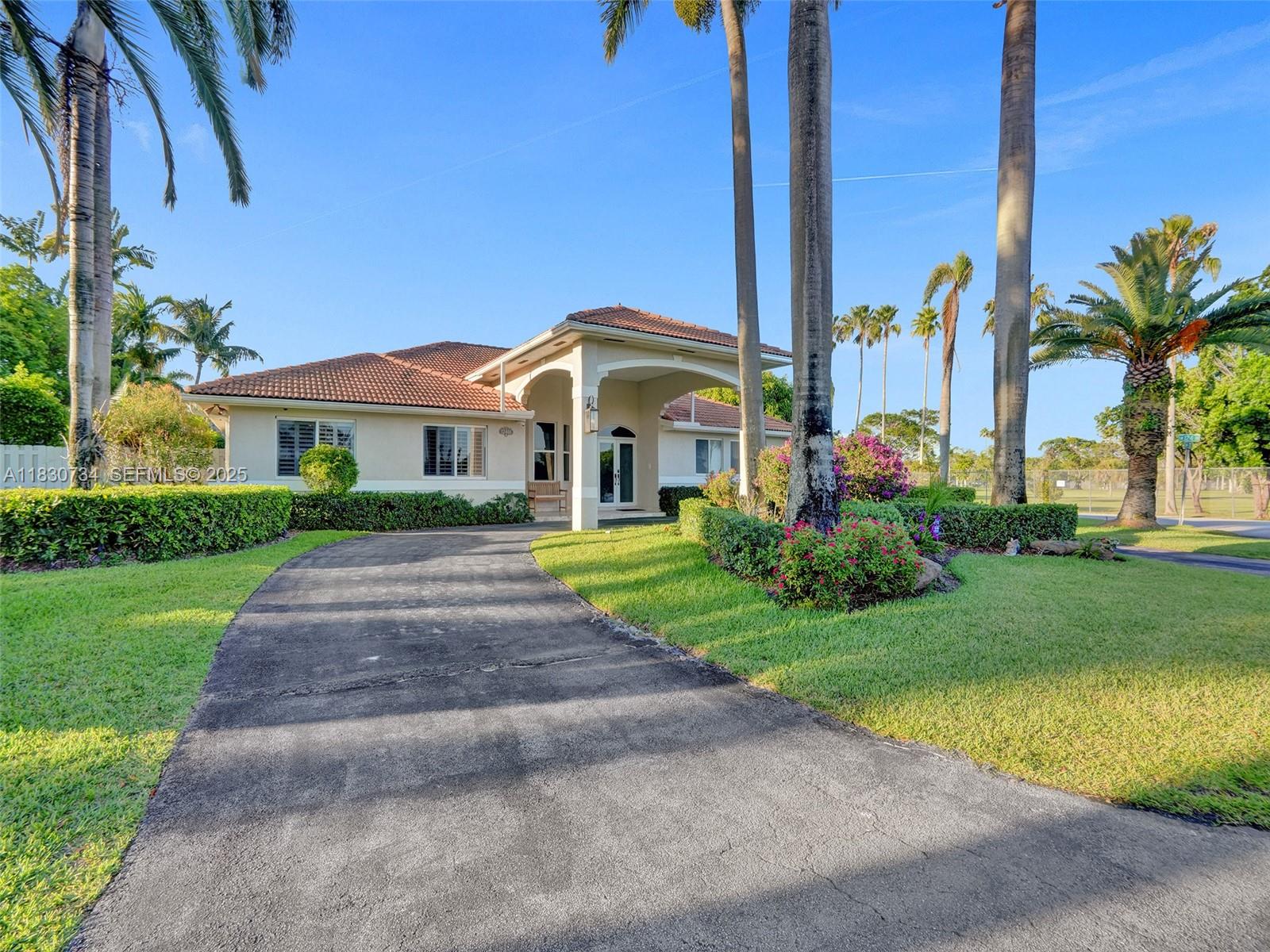 12401 Southwest 77th Street, Unit 12401 Miami, FL 33183 - Photo 68 of 95 a front view of a house with garden