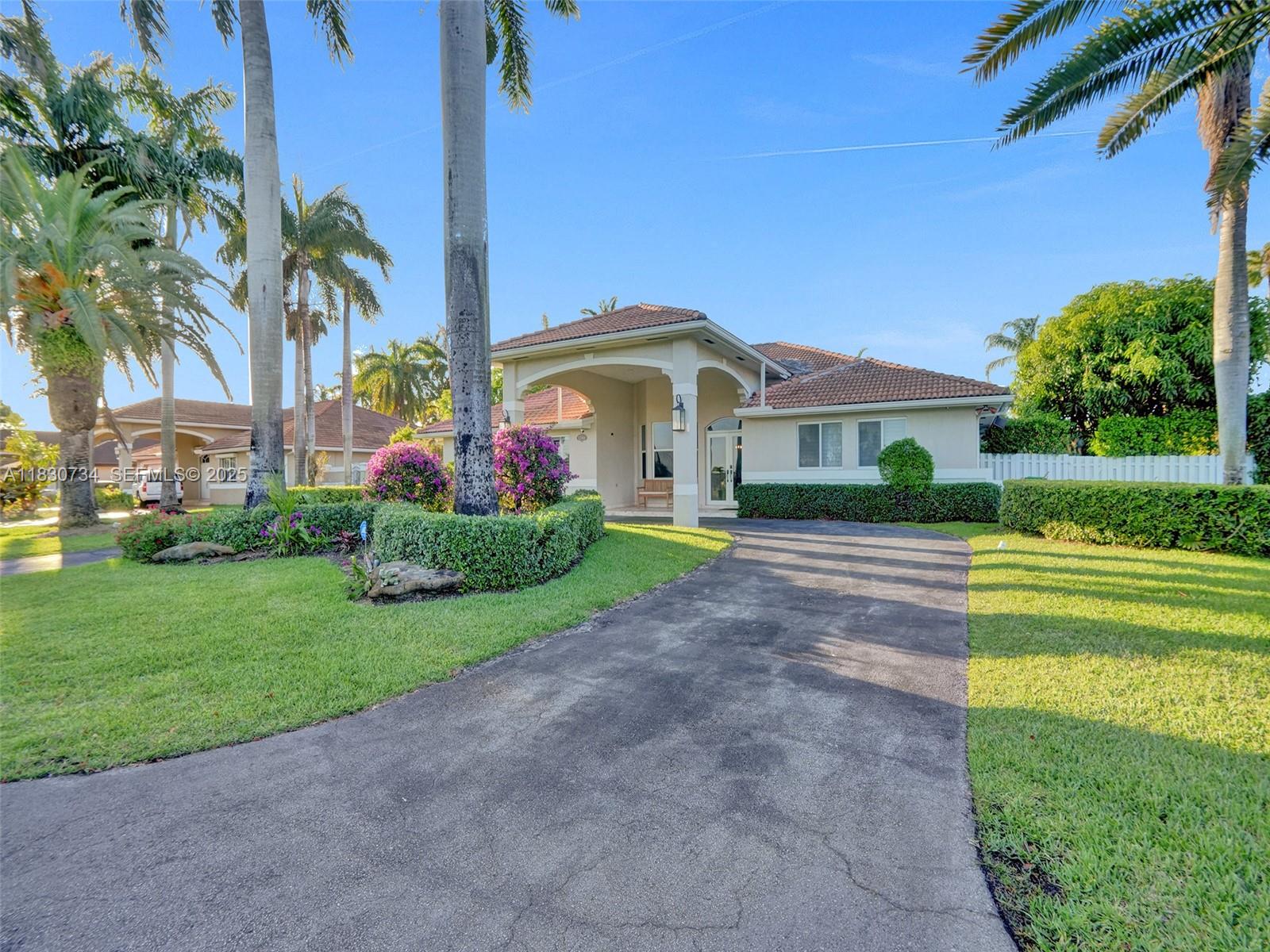 12401 Southwest 77th Street, Unit 12401 Miami, FL 33183 - Photo 70 of 95 a front view of a house with garden