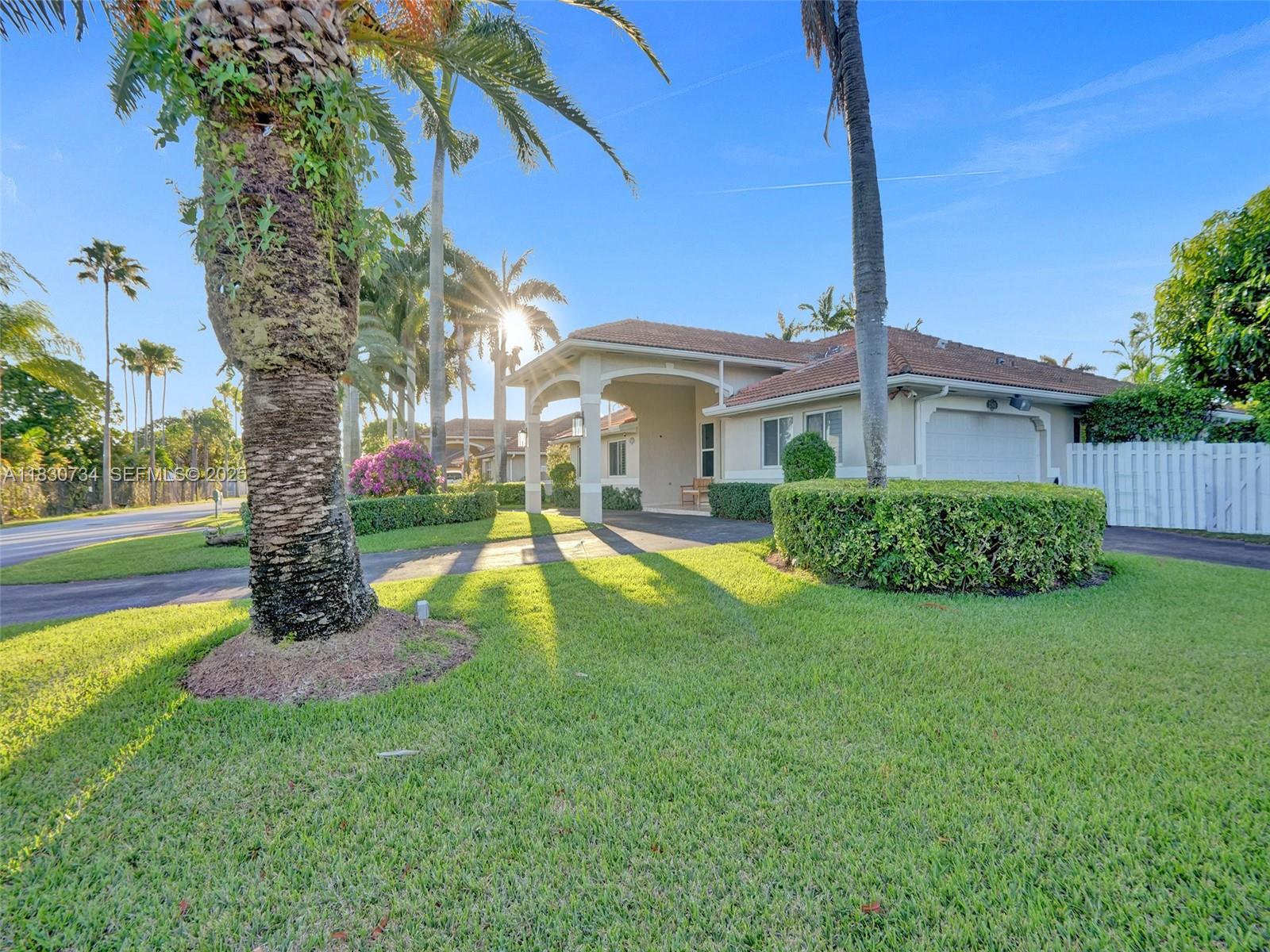 12401 Southwest 77th Street, Unit 12401 Miami, FL 33183 - Photo 73 of 95 a view of a house with a big yard plants and palm trees