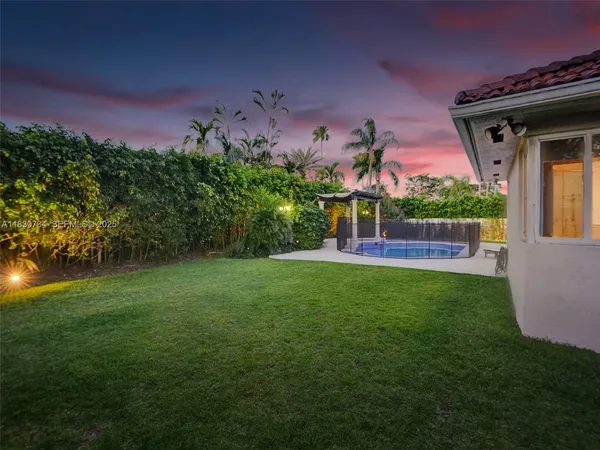 a front view of a house with a garden and trees