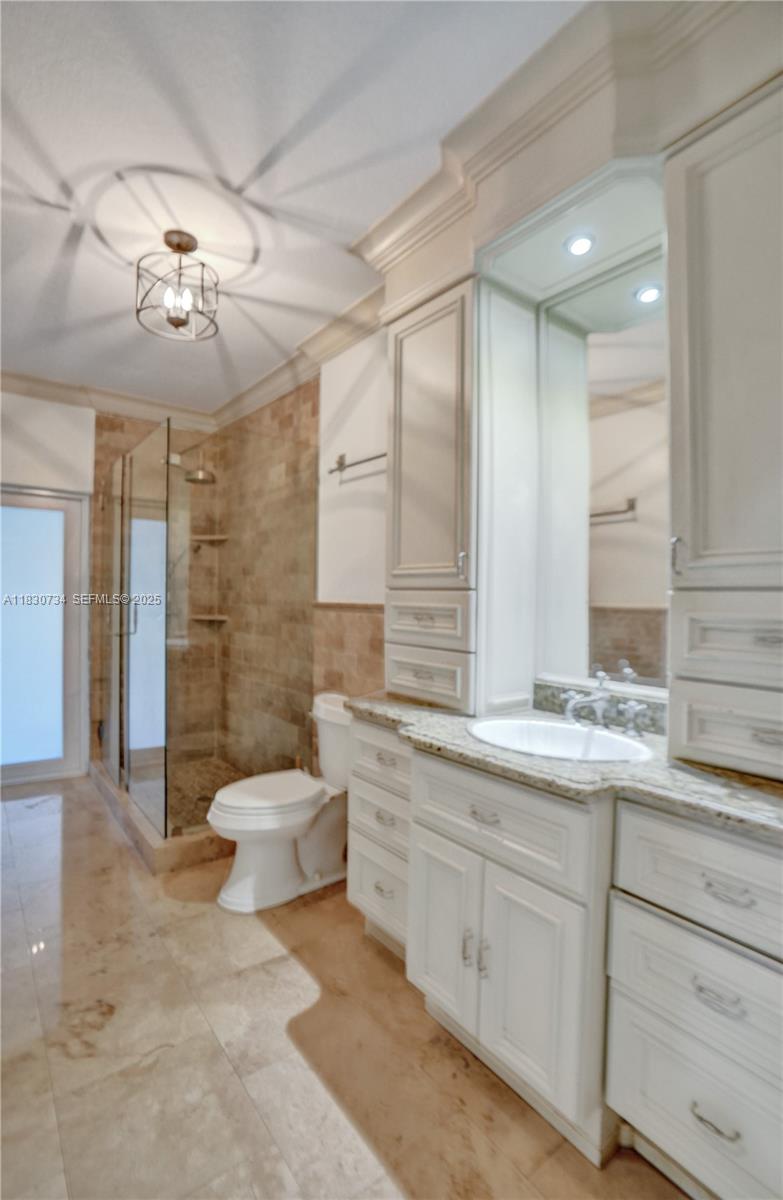 12401 Southwest 77th Street, Unit 12401 Miami, FL 33183 - Photo 87 of 95 a bathroom with a double vanity sink mirror and toilet