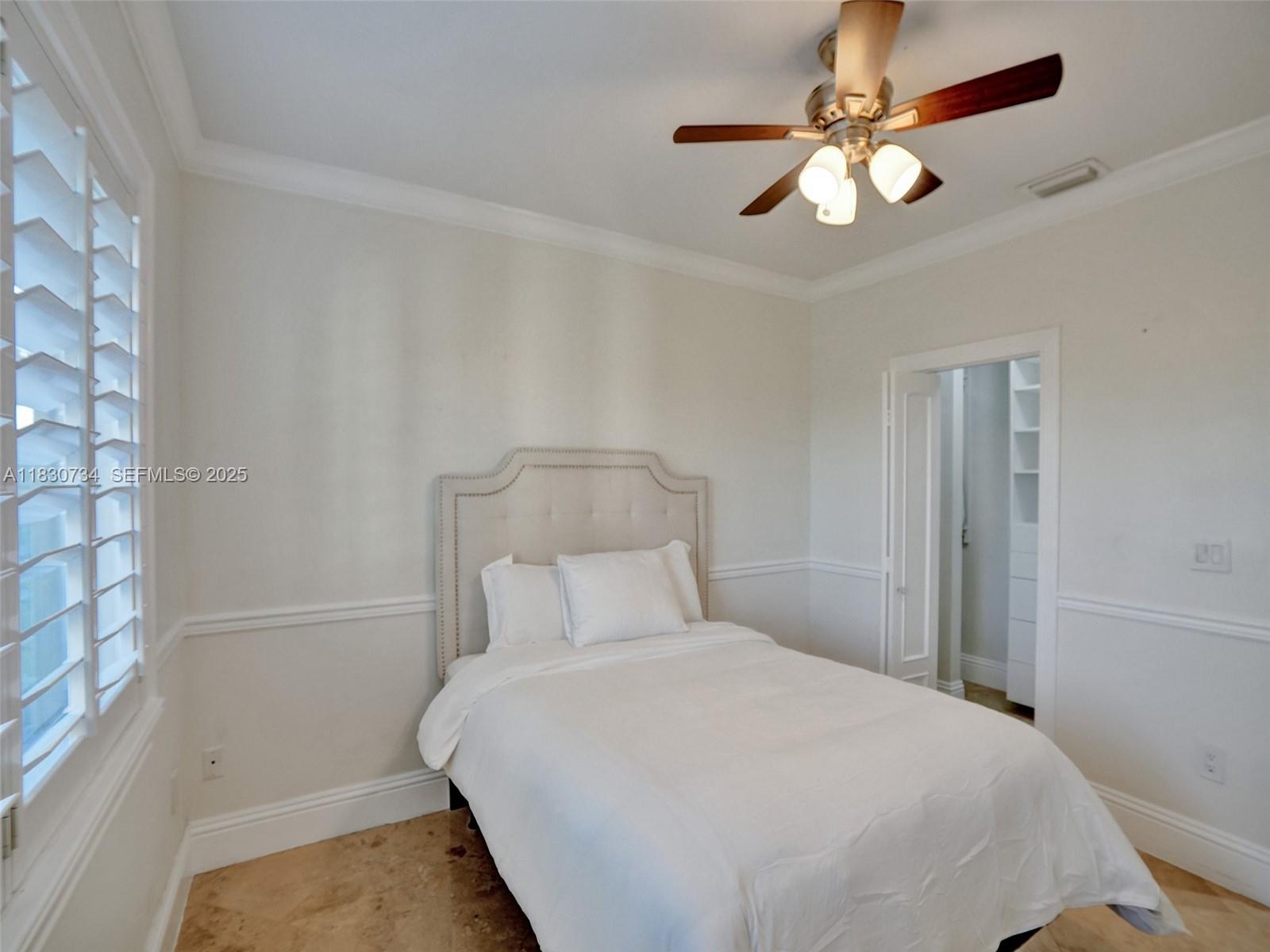 12401 Southwest 77th Street, Unit 12401 Miami, FL 33183 - Photo 89 of 95 a bedroom with a bed and a chandelier