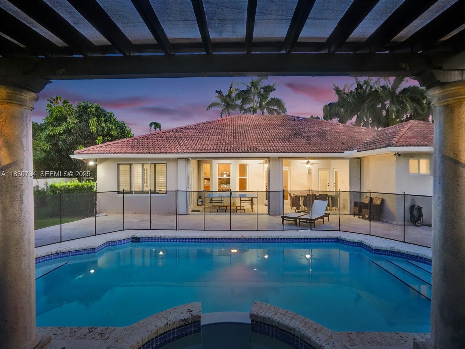 12401 Southwest 77th Street, Unit 12401 Miami, FL 33183 - Photo 10 of 95 a view of a swimming pool with a patio