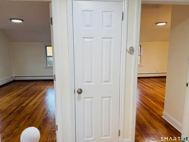 a view of a room with wooden floor and staircase