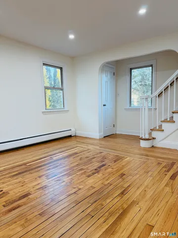 a kitchen with granite countertop white cabinets white stainless steel appliances with a sink and dishwasher