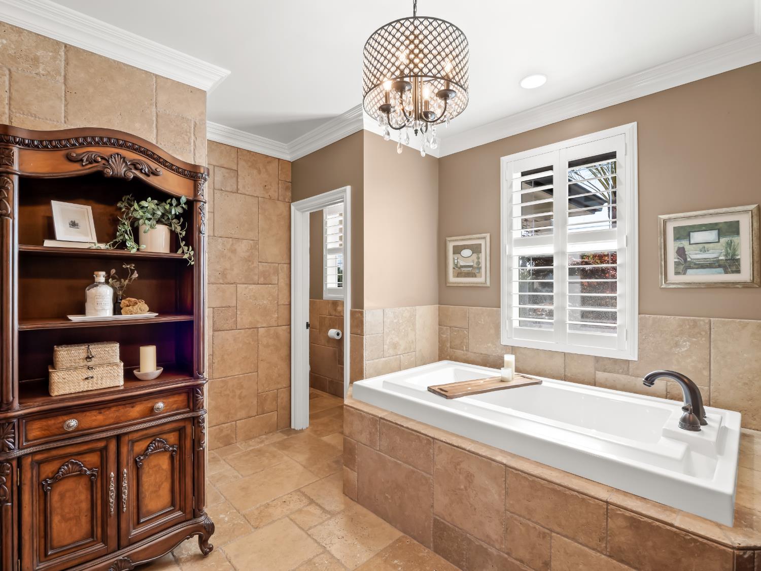 17113 Mark Road Madera, CA 93636 - Photo 34 of 99 a spacious bedroom with a bed and a chandelier