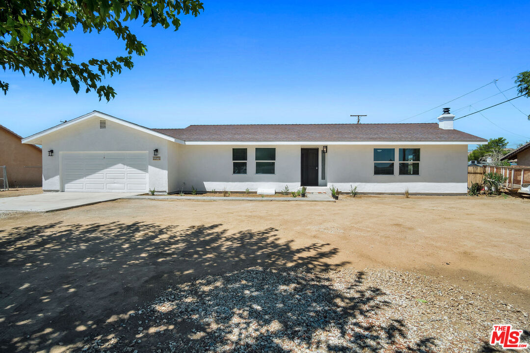 15376 Washoan Road Apple Valley, CA 92307 - Photo 1 of 40 a front view of a house with a yard