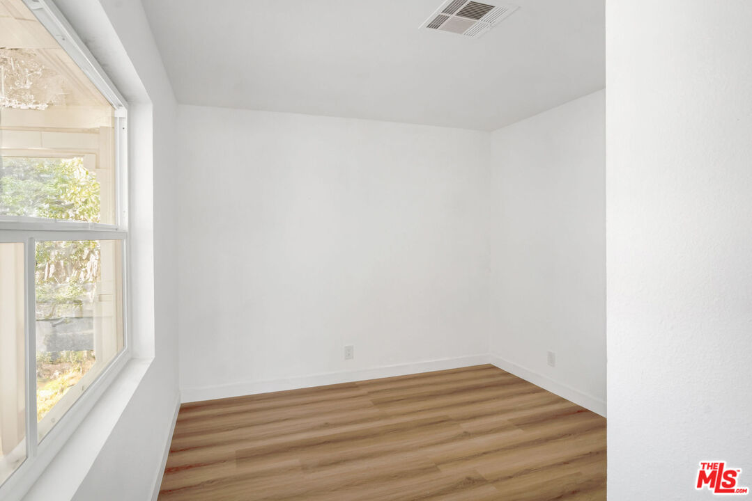 15376 Washoan Road Apple Valley, CA 92307 - Photo 12 of 40 a view of empty room with wooden floor and fan