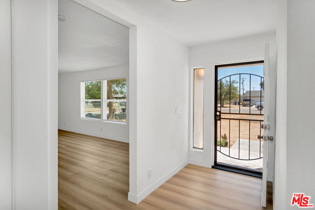 15376 Washoan Road Apple Valley, CA 92307 - Photo 14 of 40 an empty room with wooden floor and windows
