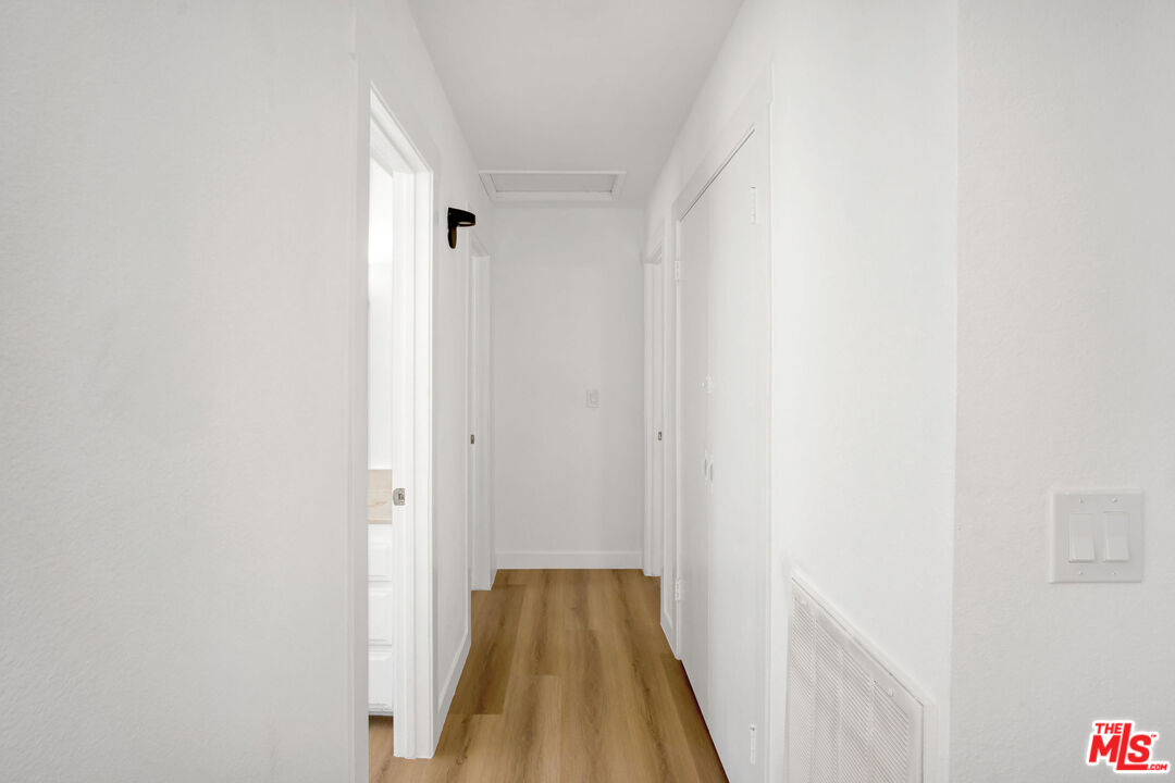 15376 Washoan Road Apple Valley, CA 92307 - Photo 16 of 40 a view of a hallway with wooden floor