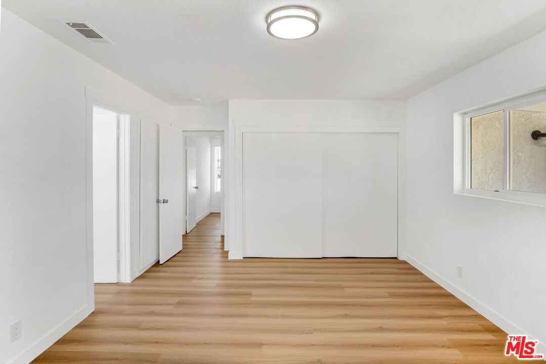 15376 Washoan Road Apple Valley, CA 92307 - Photo 20 of 40 a view of an empty room with wooden floor