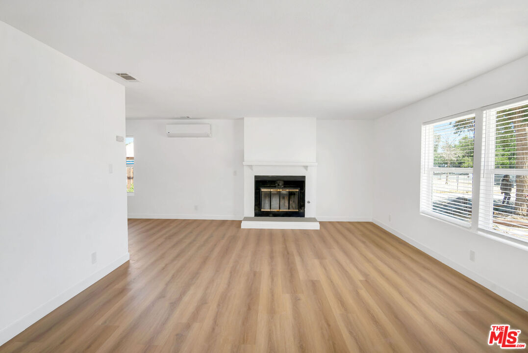 15376 Washoan Road Apple Valley, CA 92307 - Photo 27 of 40 an empty room with windows and fireplace
