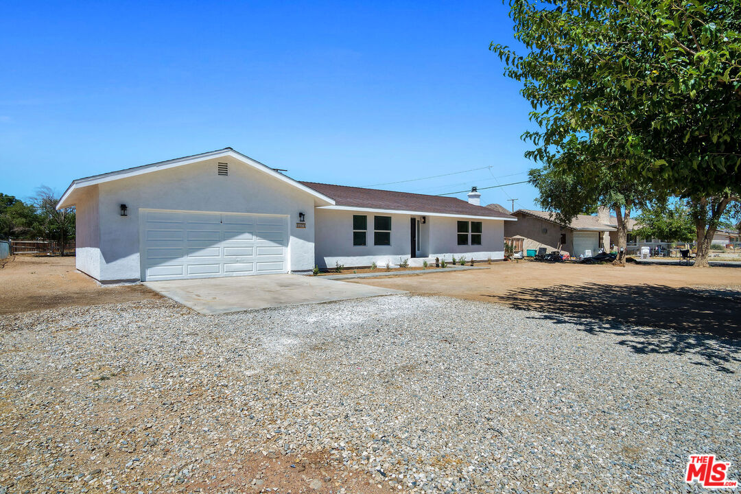 15376 Washoan Road Apple Valley, CA 92307 - Photo 3 of 40 a front view of a house with a yard