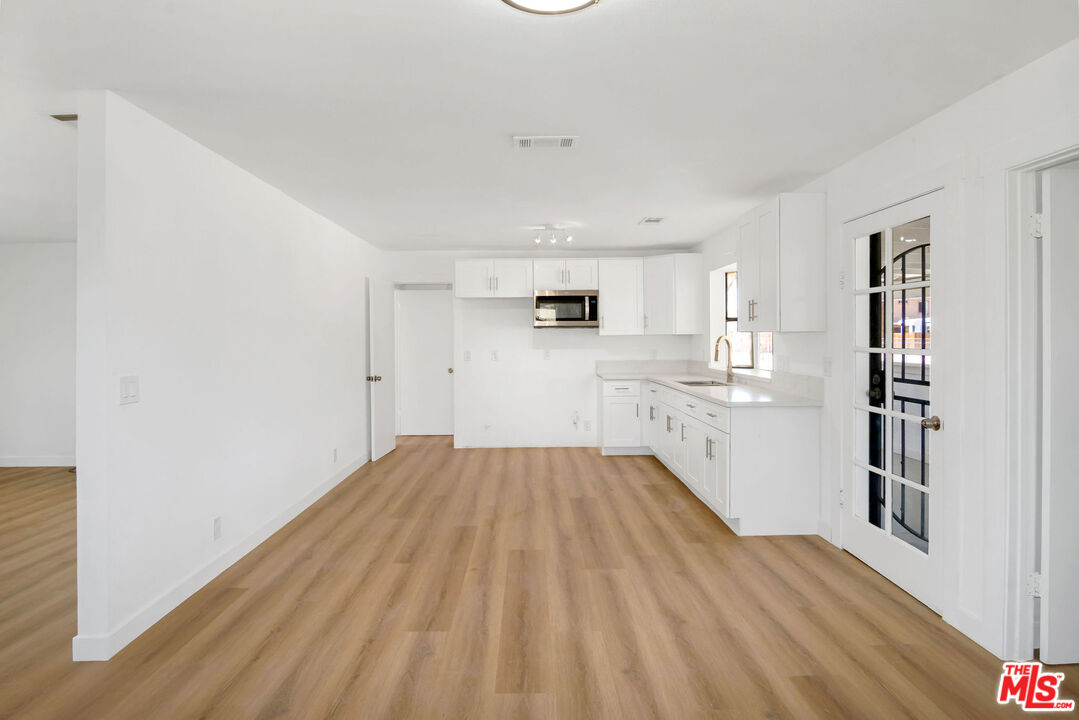 15376 Washoan Road Apple Valley, CA 92307 - Photo 5 of 40 a view of kitchen and wooden floor