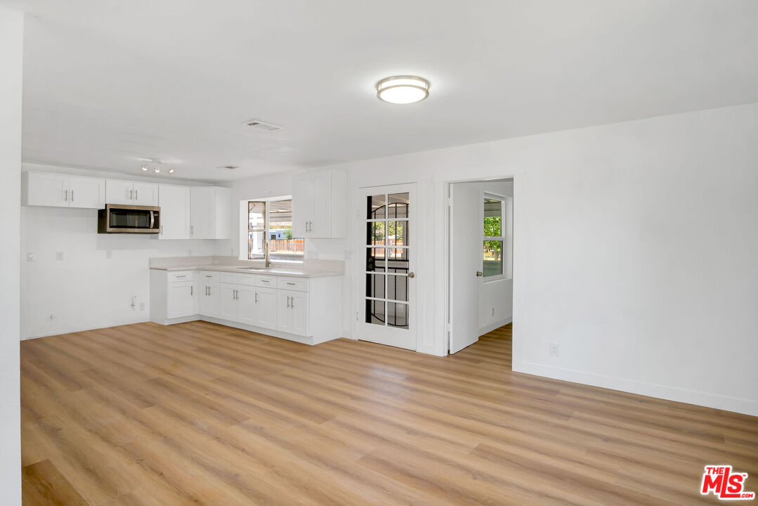 15376 Washoan Road Apple Valley, CA 92307 - Photo 6 of 40 a view of a kitchen with wooden floor and a kitchen