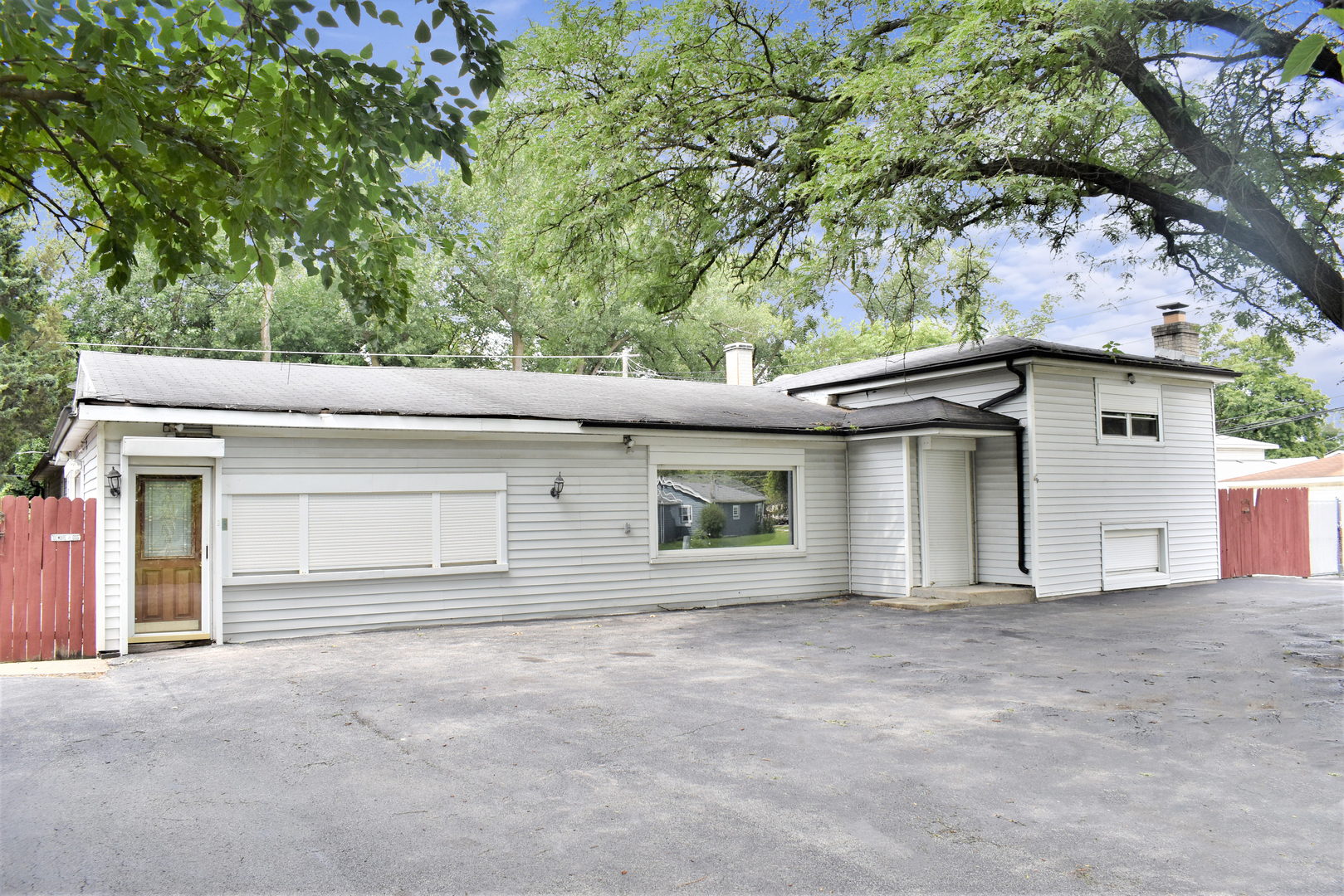 front view of a house with a tree