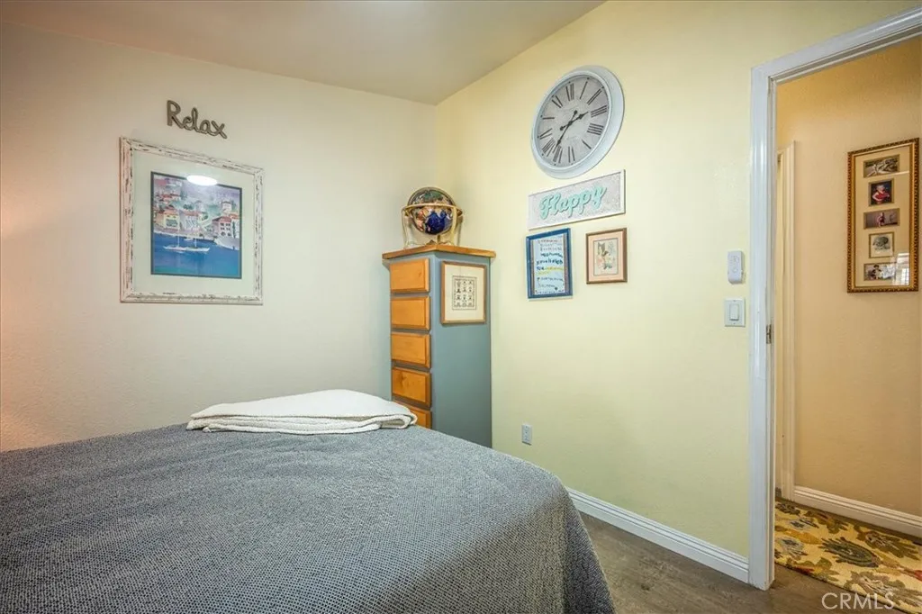 15181 Van Buren, Unit 178 Riverside, CA 92504 - Photo 15 of 52 a bedroom with a bed and wall painting